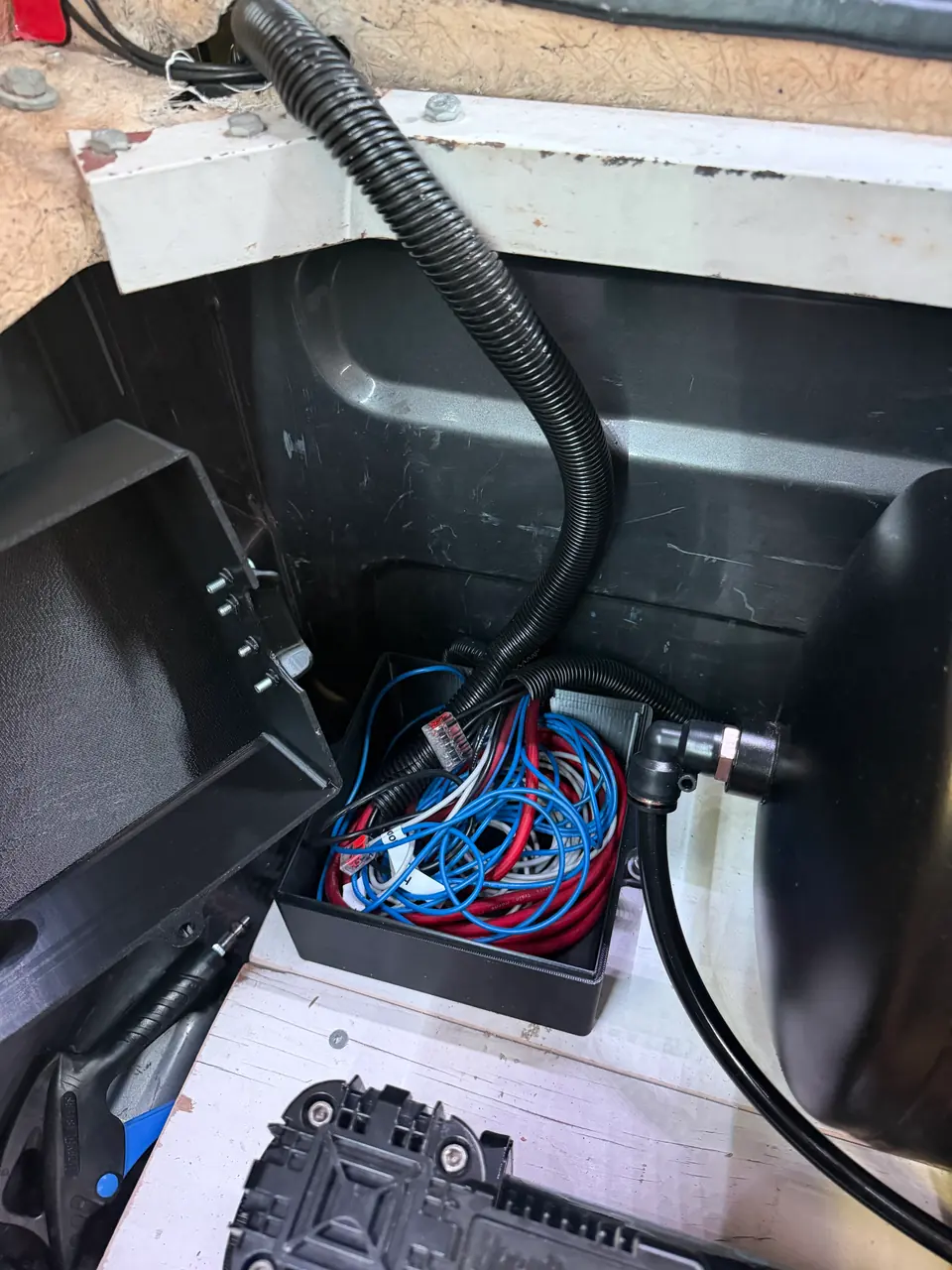 The wiring box in the bed, which I also designed and printed: the added circuits meet here, then run through a 1-inch wire loom to the switch panels up front