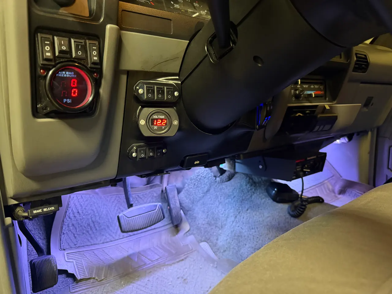 Installed under the steering column, alongside air-pressure and voltage gauges