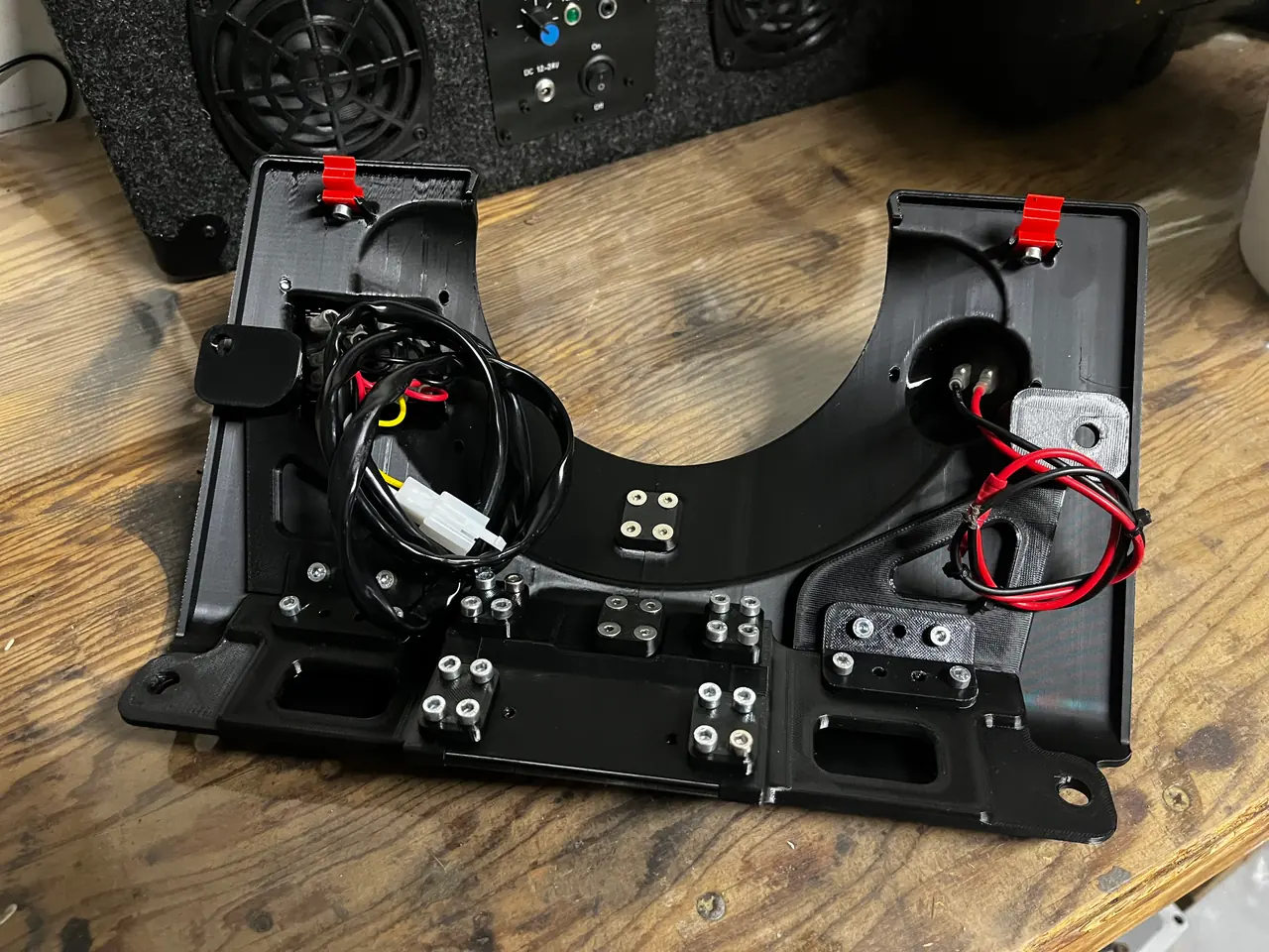 A printed panel on the bench, wired and ready to fit