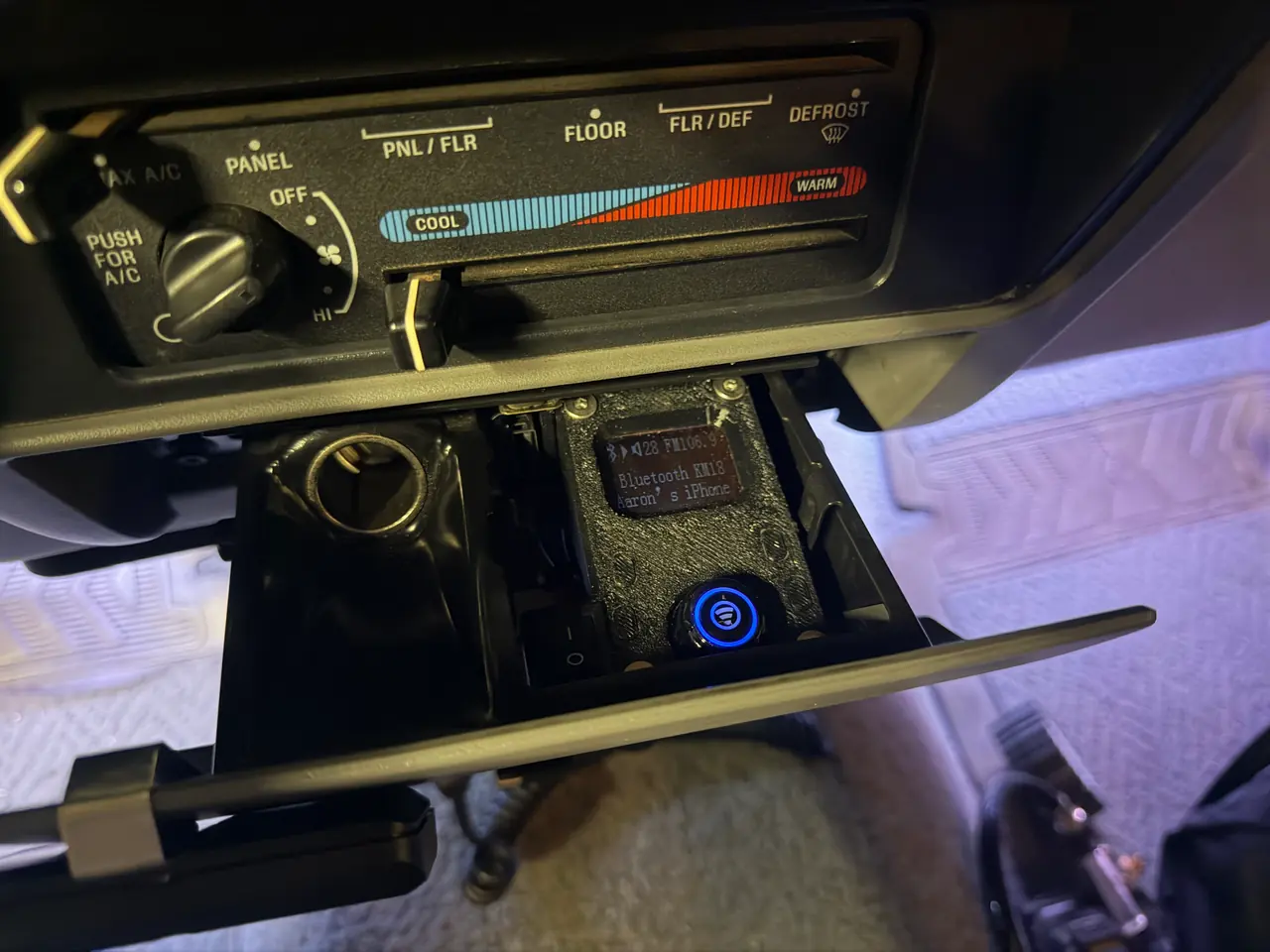 Installed in the dash tray, next to the free accessory outlet